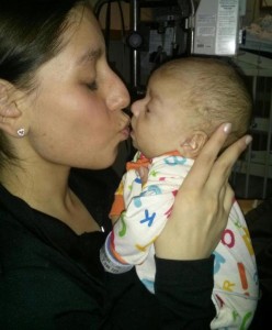 Picture of Lindsey Nagel kissing newborn son, Rico.